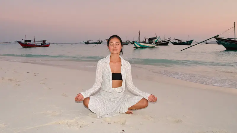 Peaceful dawn meditation by the ocean in Sanur, Bali