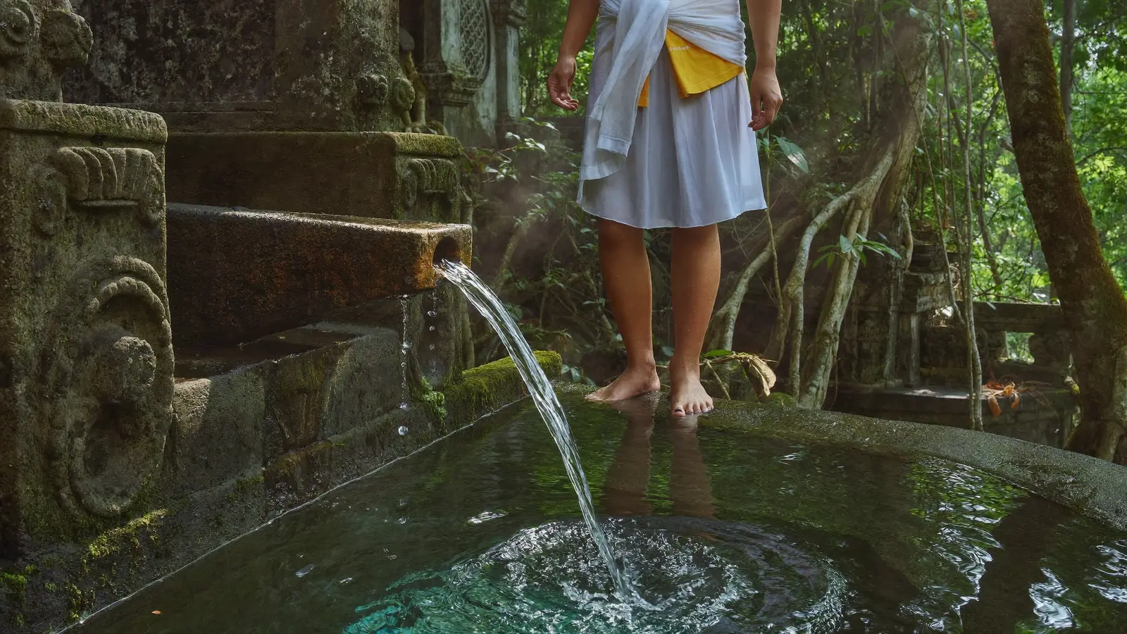 Traditional Melukat water purification ceremony at a Balinese temple