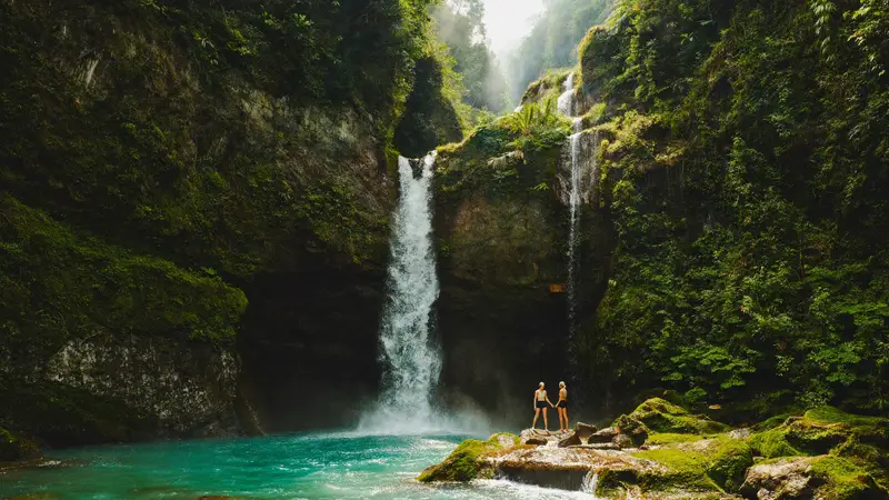 Lush Bali jungle waterfall with turquoise pool on a wellness retreat excursion